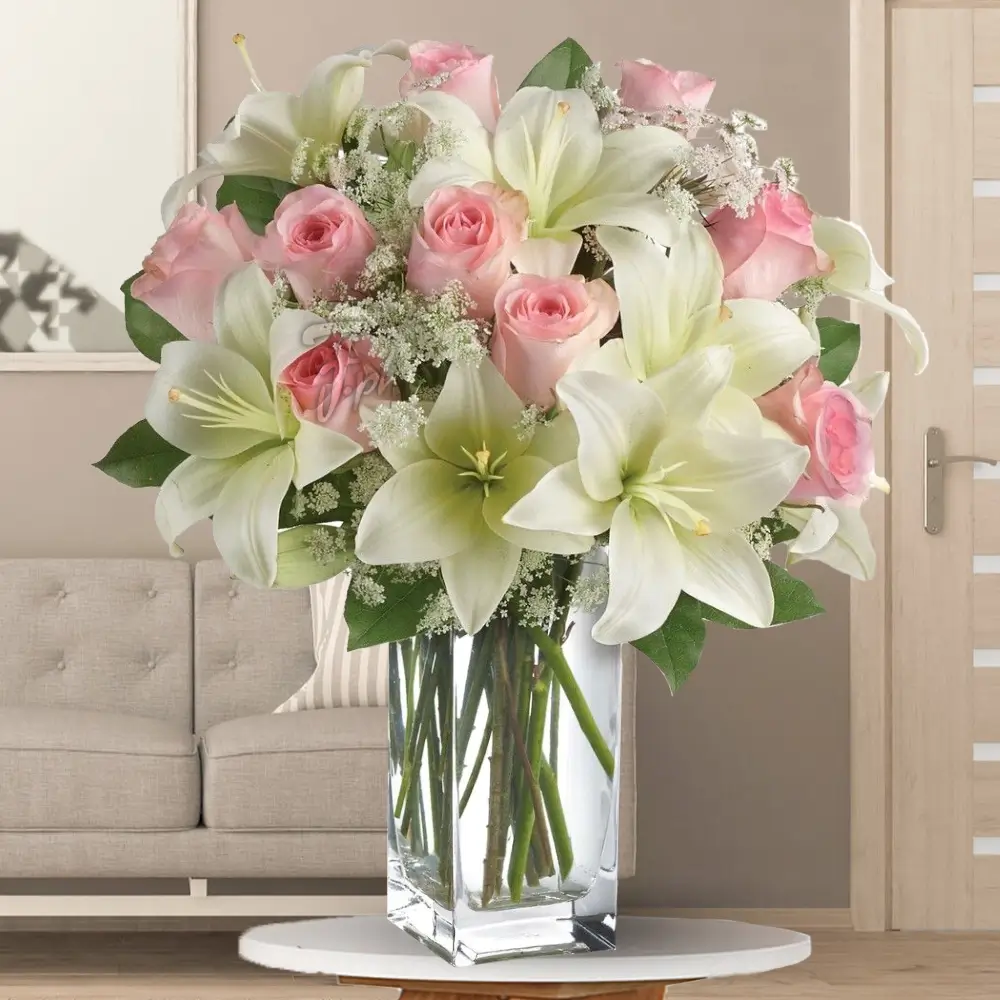 3 white lily, and 15 pink roses in a glass vase