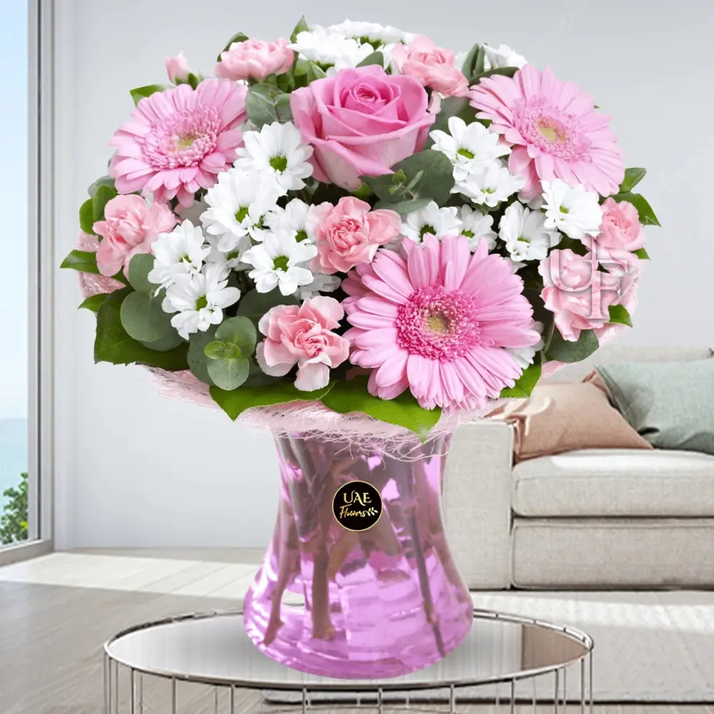 4 white chrysanthemum, 3 pink gerbera, 5 pink carnations, and 1 pink rose in a vase