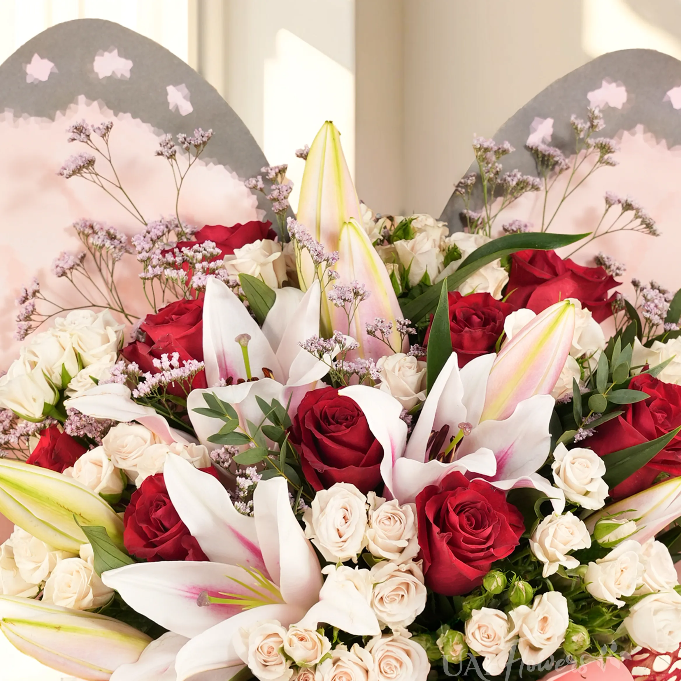 Butterfly bouquet with 2 pink lilies, 10 red roses, and 5 white spray roses