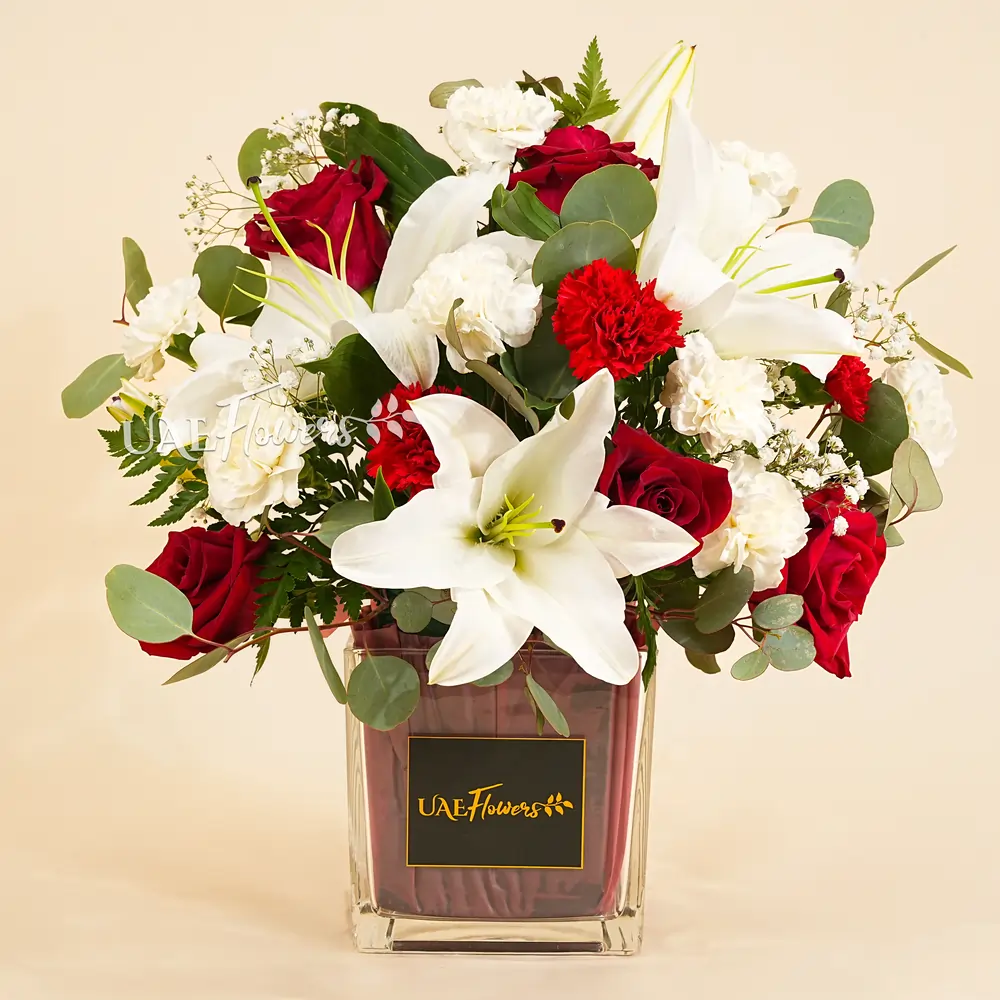 1 white lily, 10 white carnation, 4 red roses, and 3 red carnations in a red cube vase