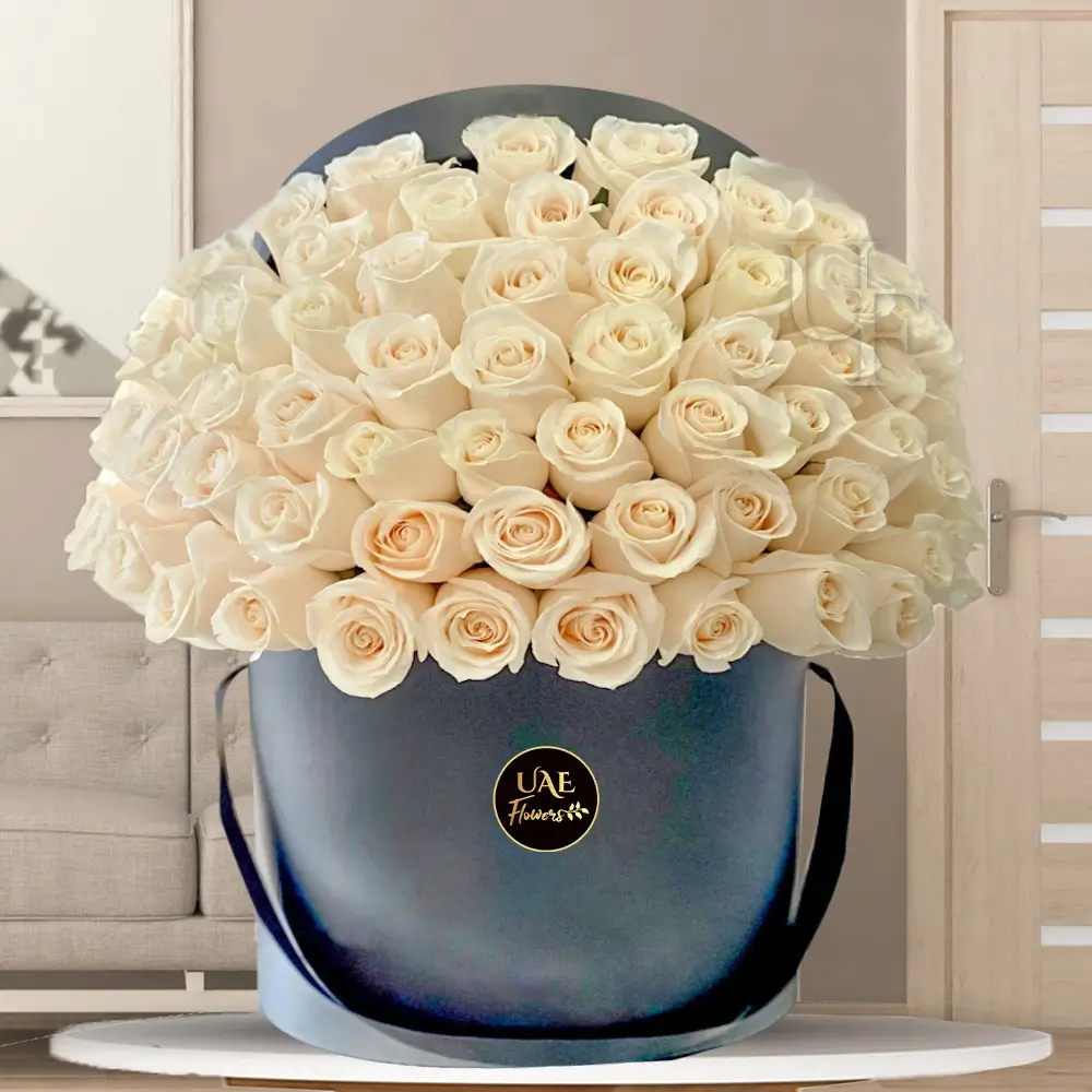 Black round box with 40 white roses and green fillers, elegantly arranged.