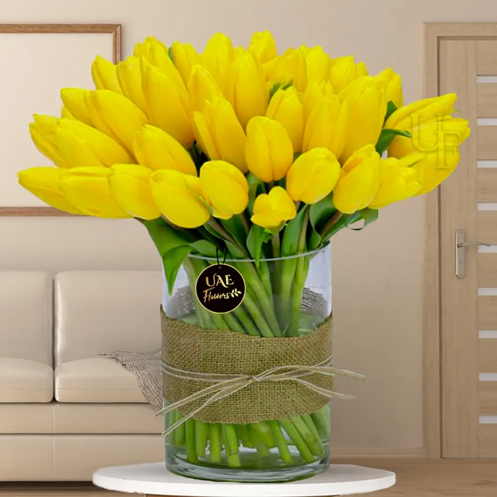 30 yellow tulips in a glass vase