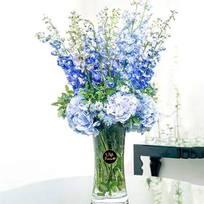 vase arrangement of fresh delphinium and hydrangea