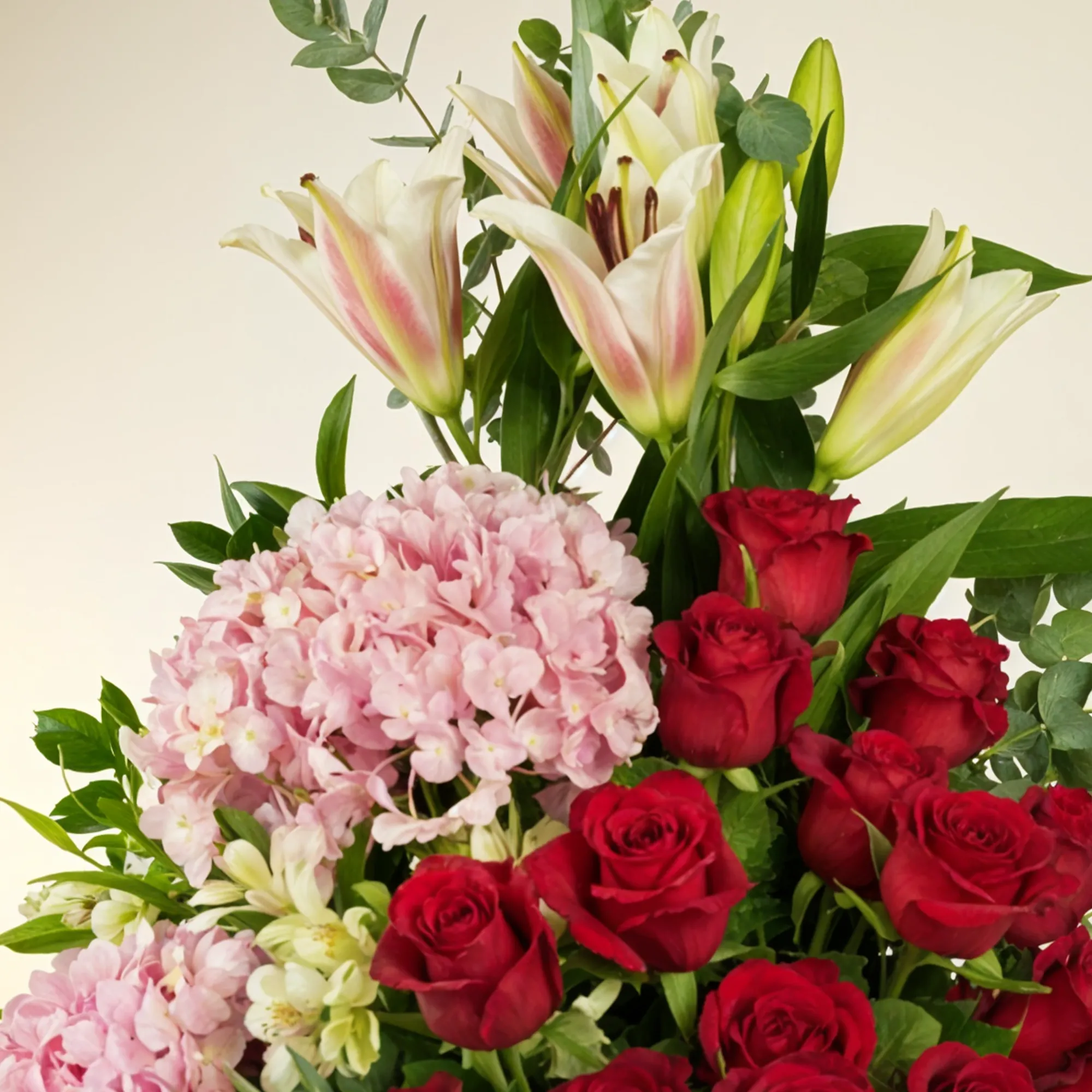 2 pink hydrangeas, 2 pink lilies, 2 white alstroemerias, 15 red roses