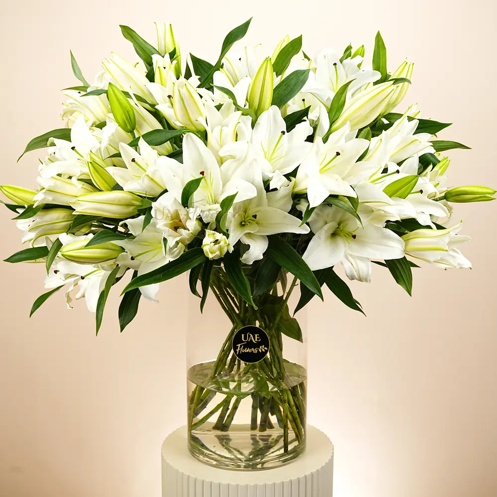 Glass vase with 20 white lilies elegantly arranged, perfect as a centerpiece or gift for weddings, anniversaries, or special occasions.