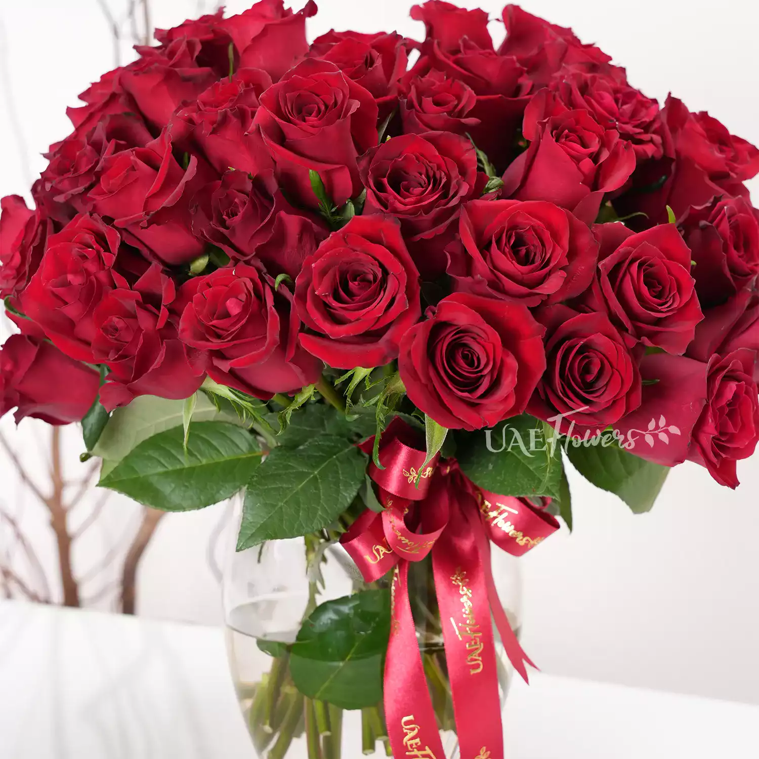 vase arrangement of 40 red roses with green fillers