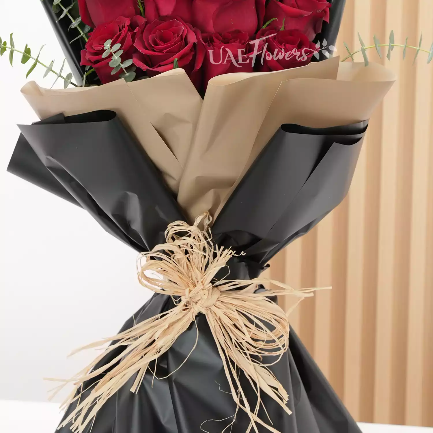 20 red roses with fillers and medium-sized brown teddy.
