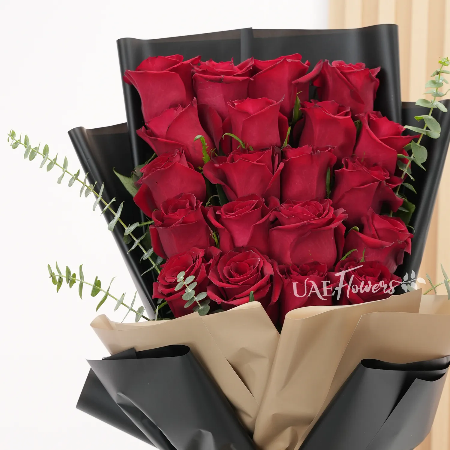 20 red roses with fillers and medium-sized brown teddy.