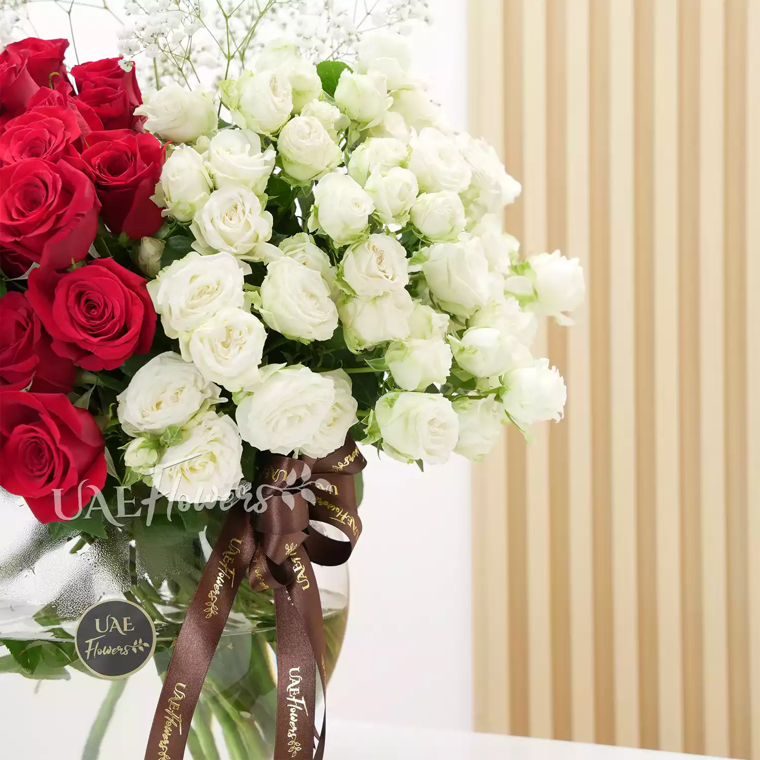 vase of 40 red roses and 10 white spray roses with baby's breath