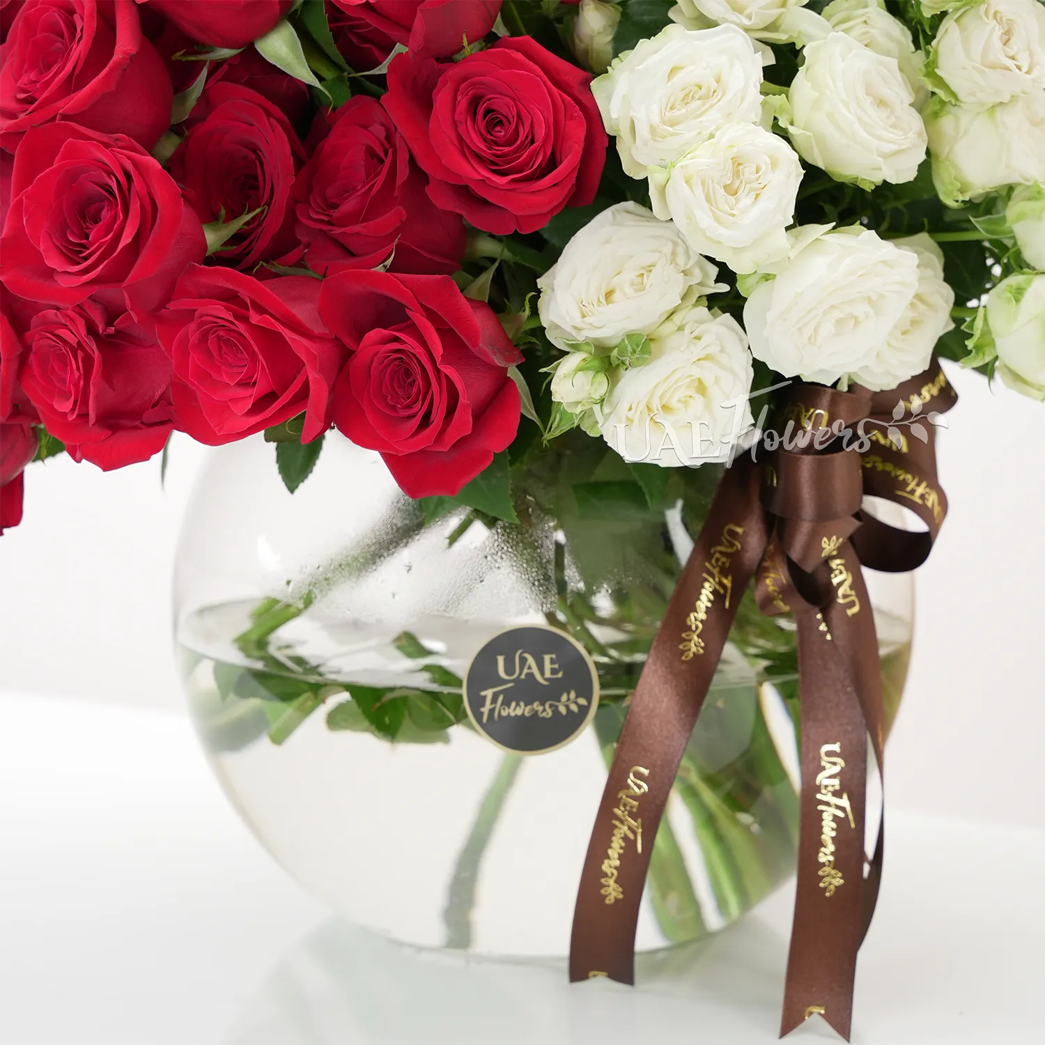 vase of 40 red roses and 10 white spray roses with baby's breath