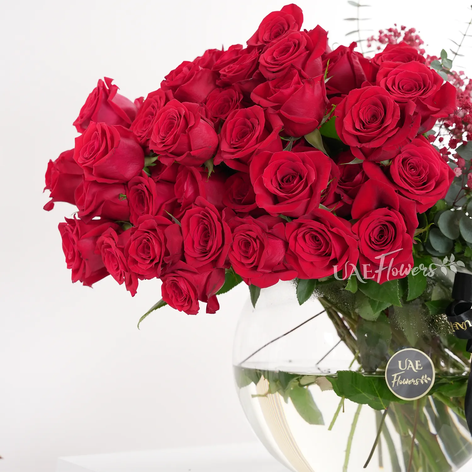 red roses, eucalyptus, and red baby's breath