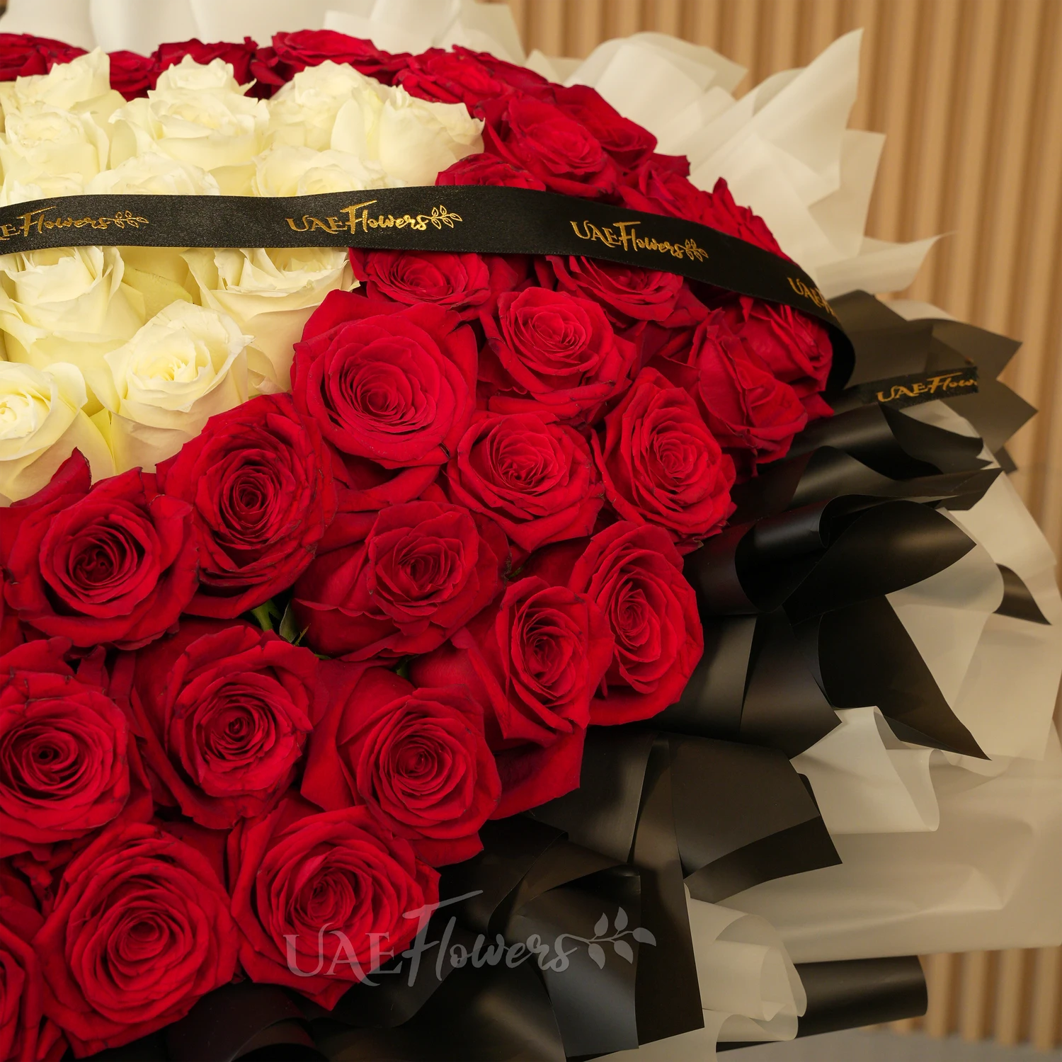 heart-shaped bouquet with 100 red and 50 white roses