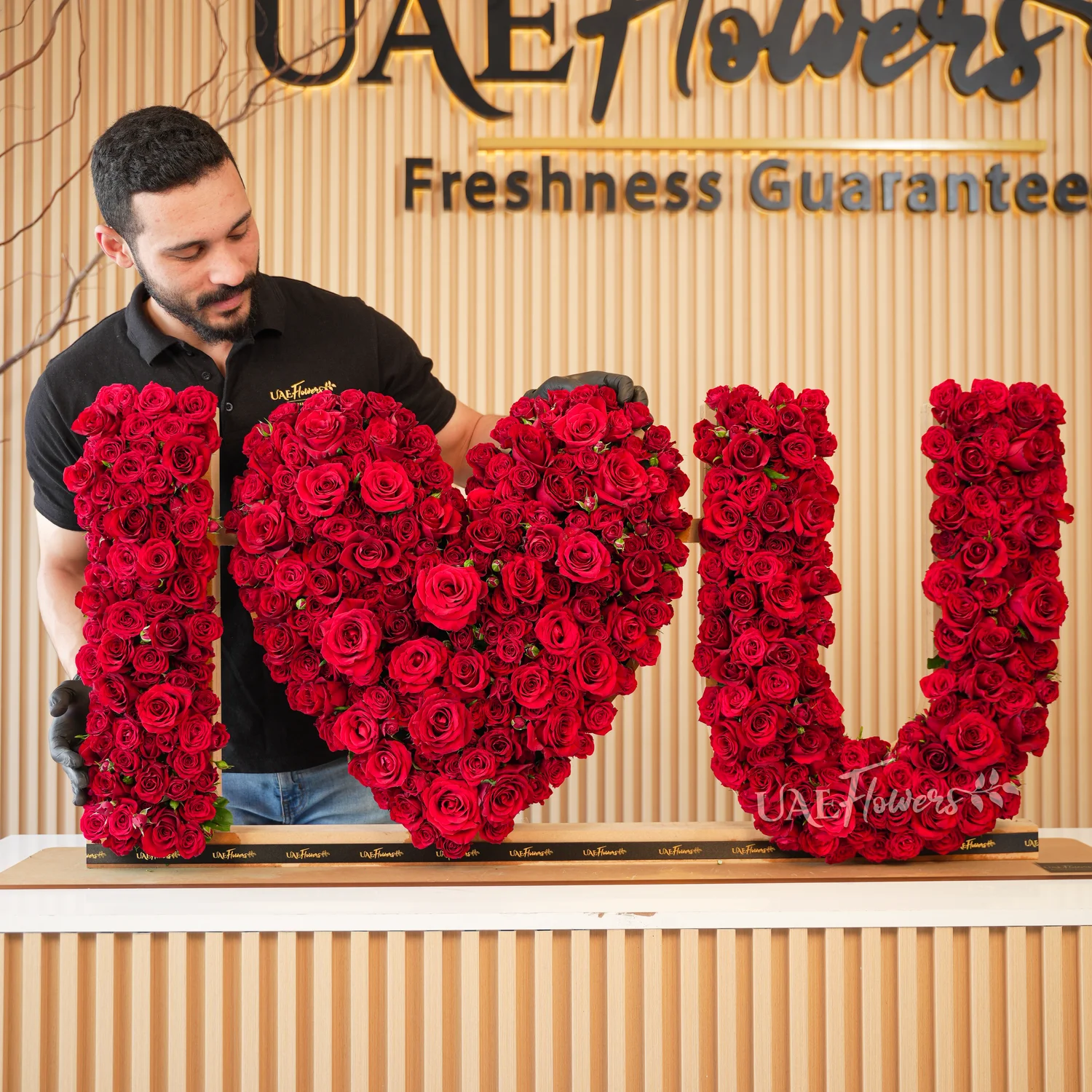 350 to 400 red spray rose buds arranged in an I Love You shape