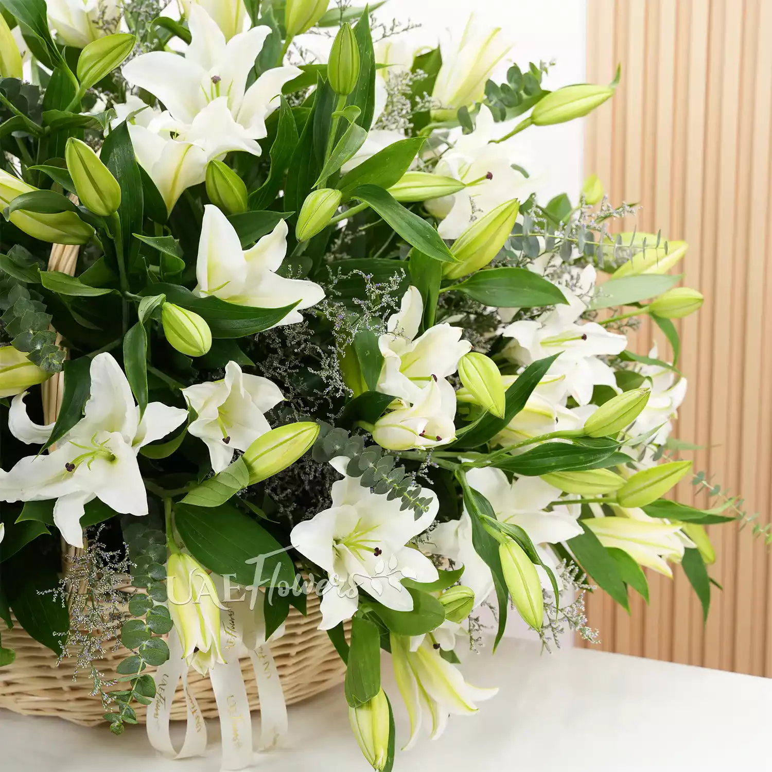 40 white lilies complemented by green fillers
