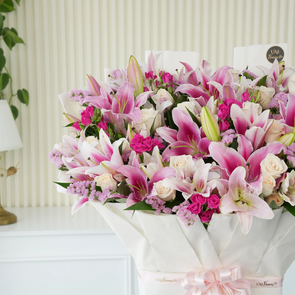 Bouquet of 10 pink lilies, 30 white roses, 10 pink spray roses with green fillers tied with ribbons.