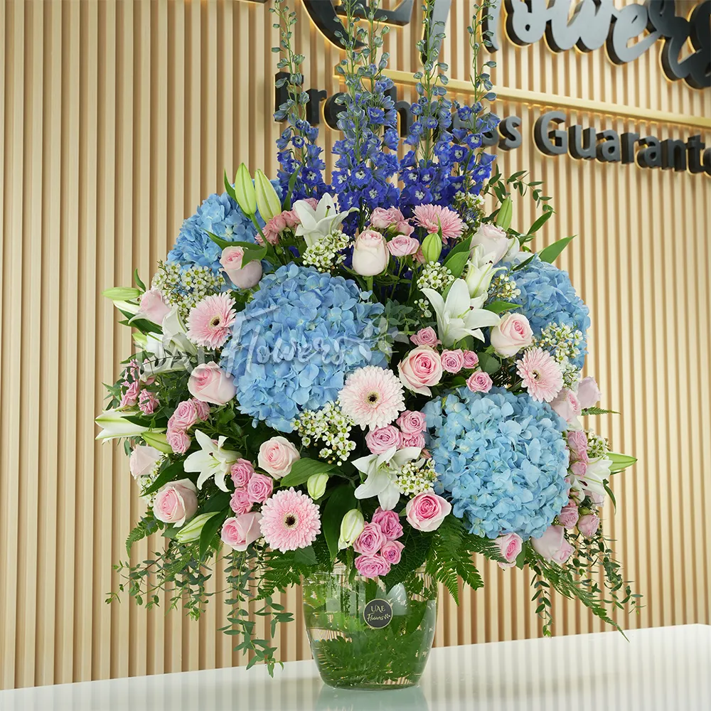 4 blue hydrangeas, 8 white lilies, 5 blue delphiniums, 15 pink roses, 10 pink spray roses,