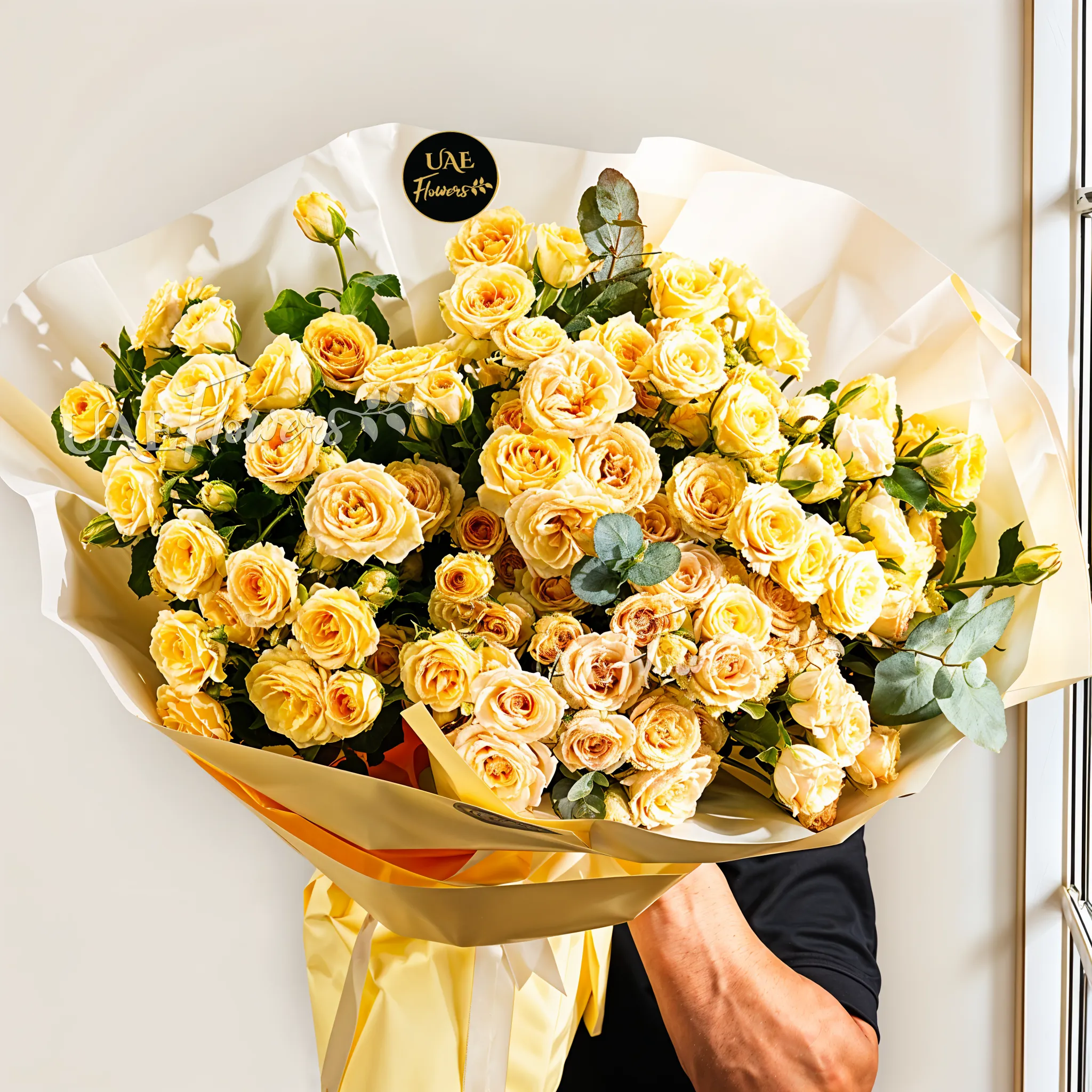 bouquet of 25 peach spray roses with eucalyptus in a wrapping