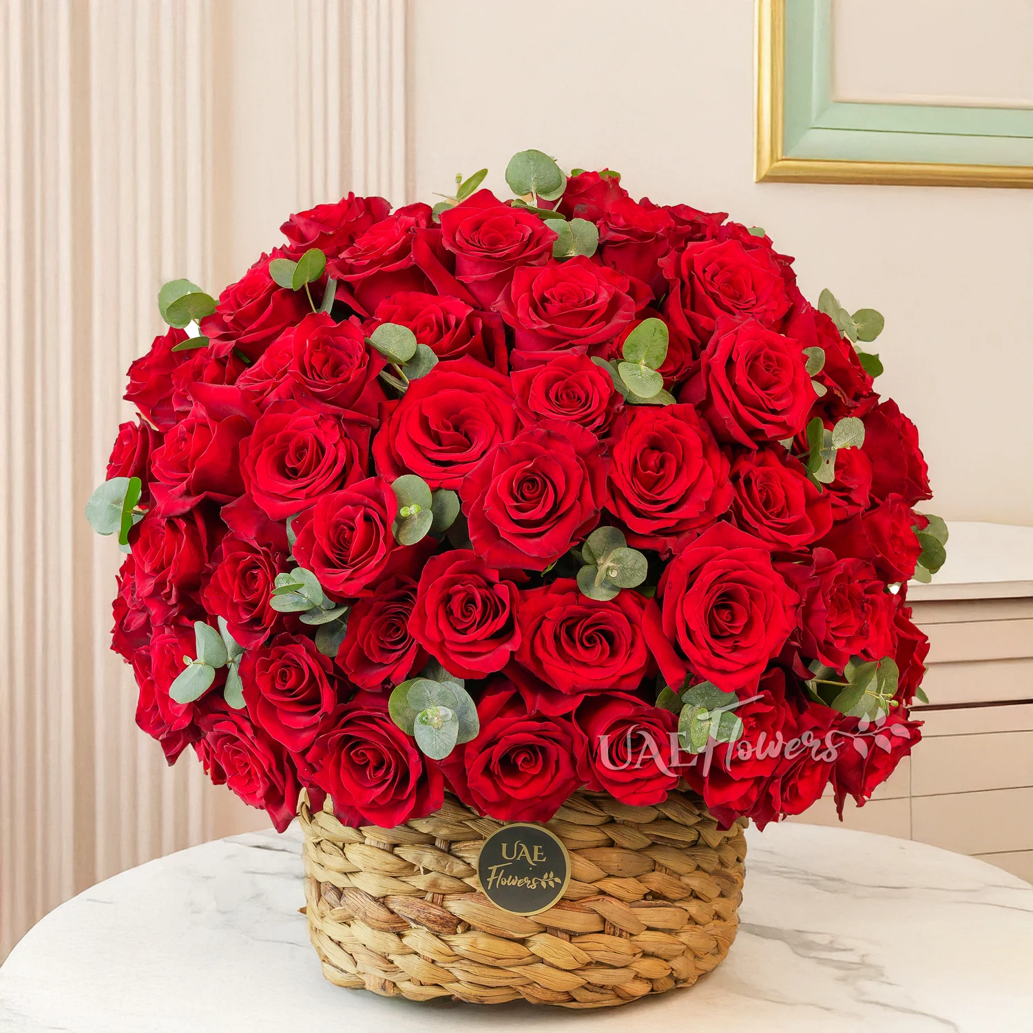 basket arrangement of 60 red roses with eucalyptus leaves