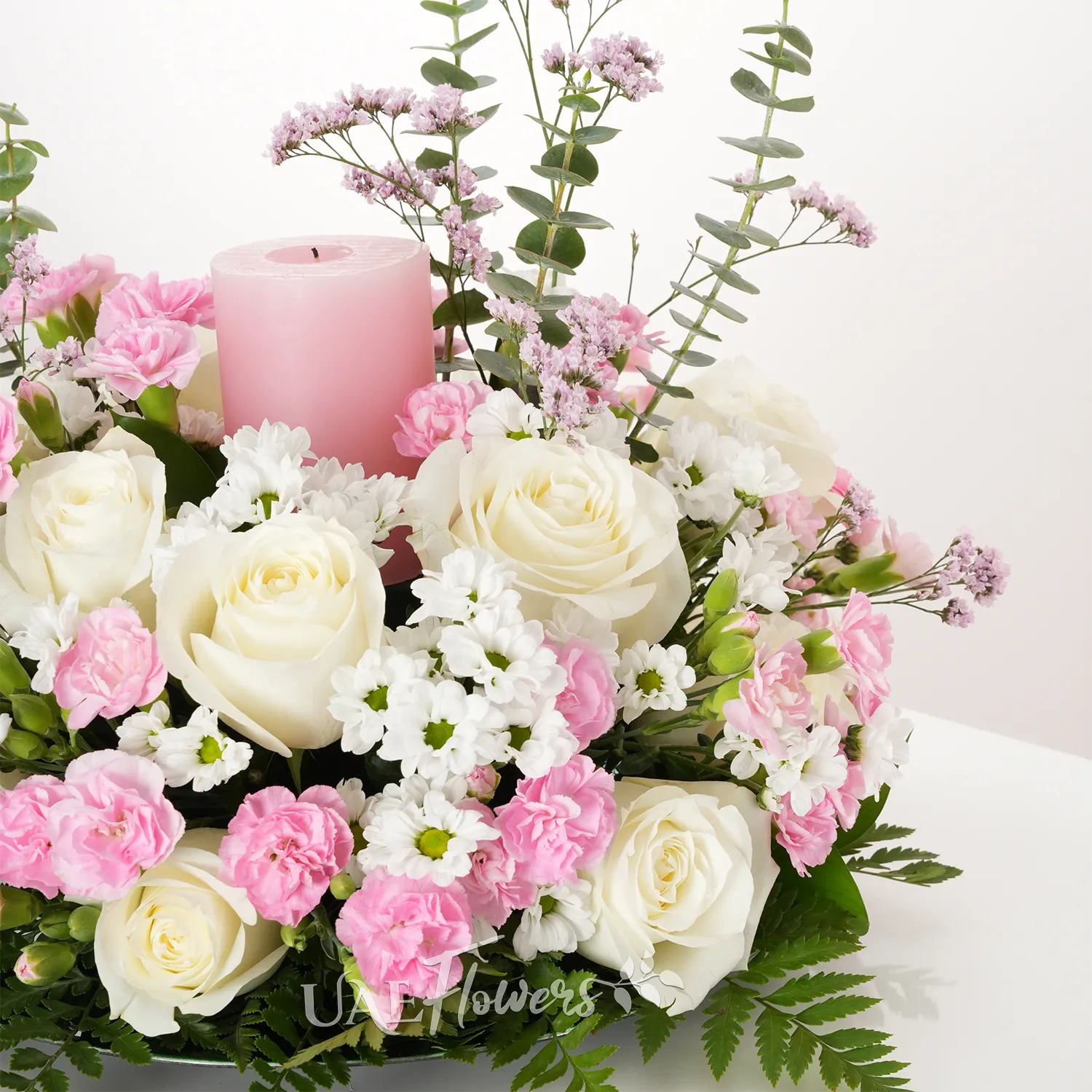 15 white roses, 5 chrysanthemums, 10 pink carnations, and pink candle