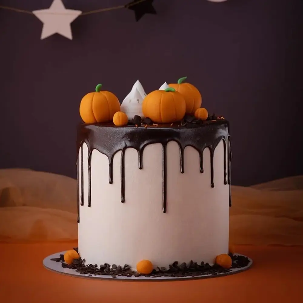 A Halloween drip cake weighing 2 kg filled with chocolate ganache A Halloween drip cake weighing 2 kg filled with chocolate ganache