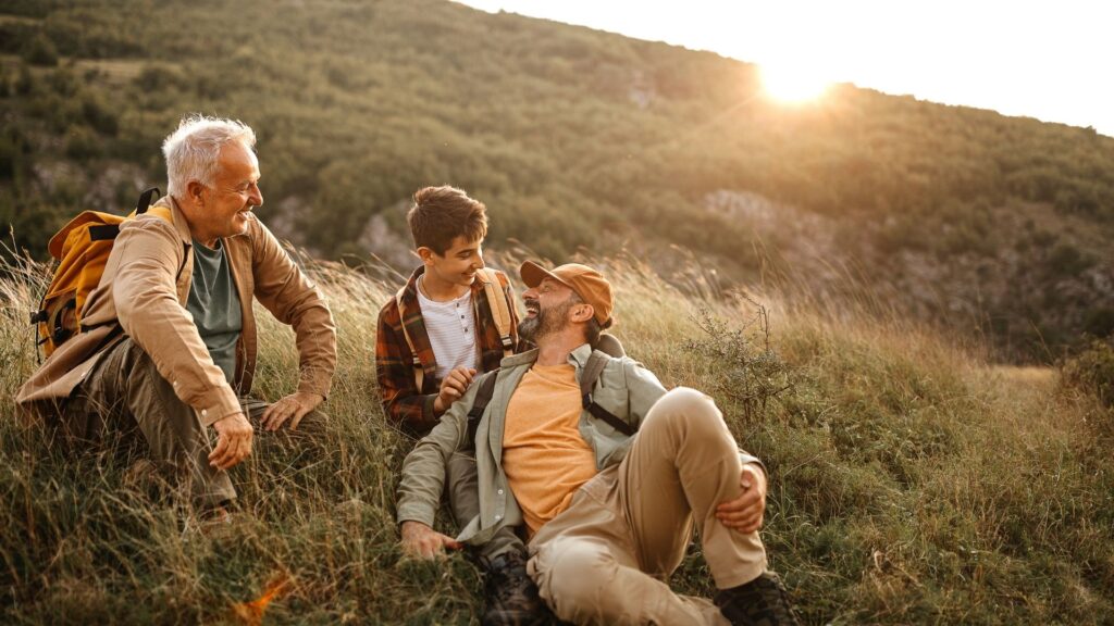 A Child and a Man with an old man in field