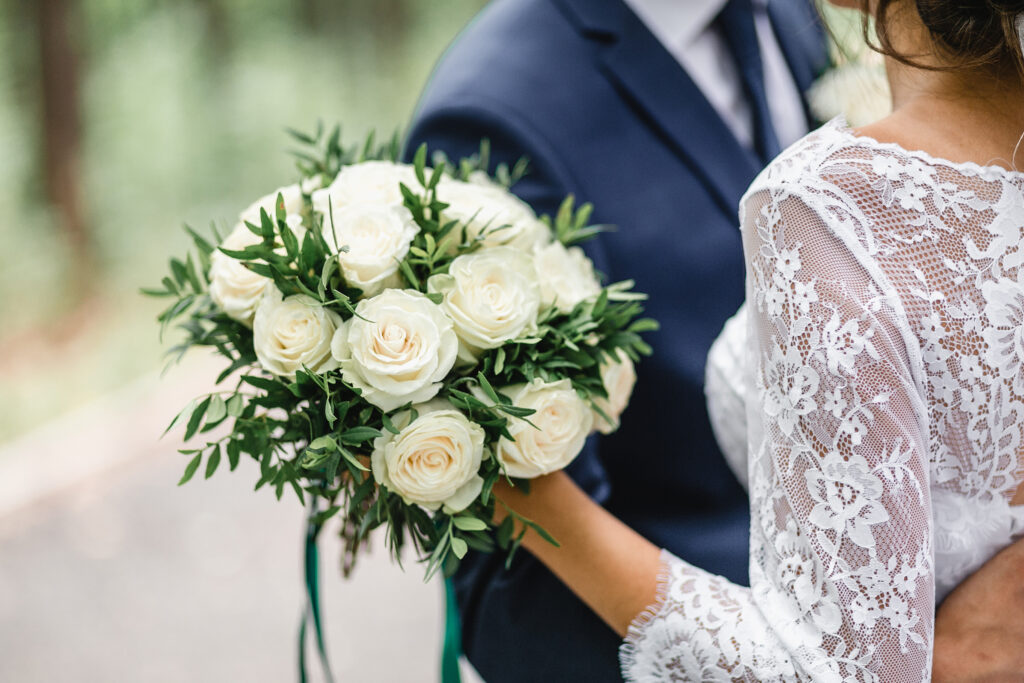 Bride hugging a man with beautiful Roses Bouquet